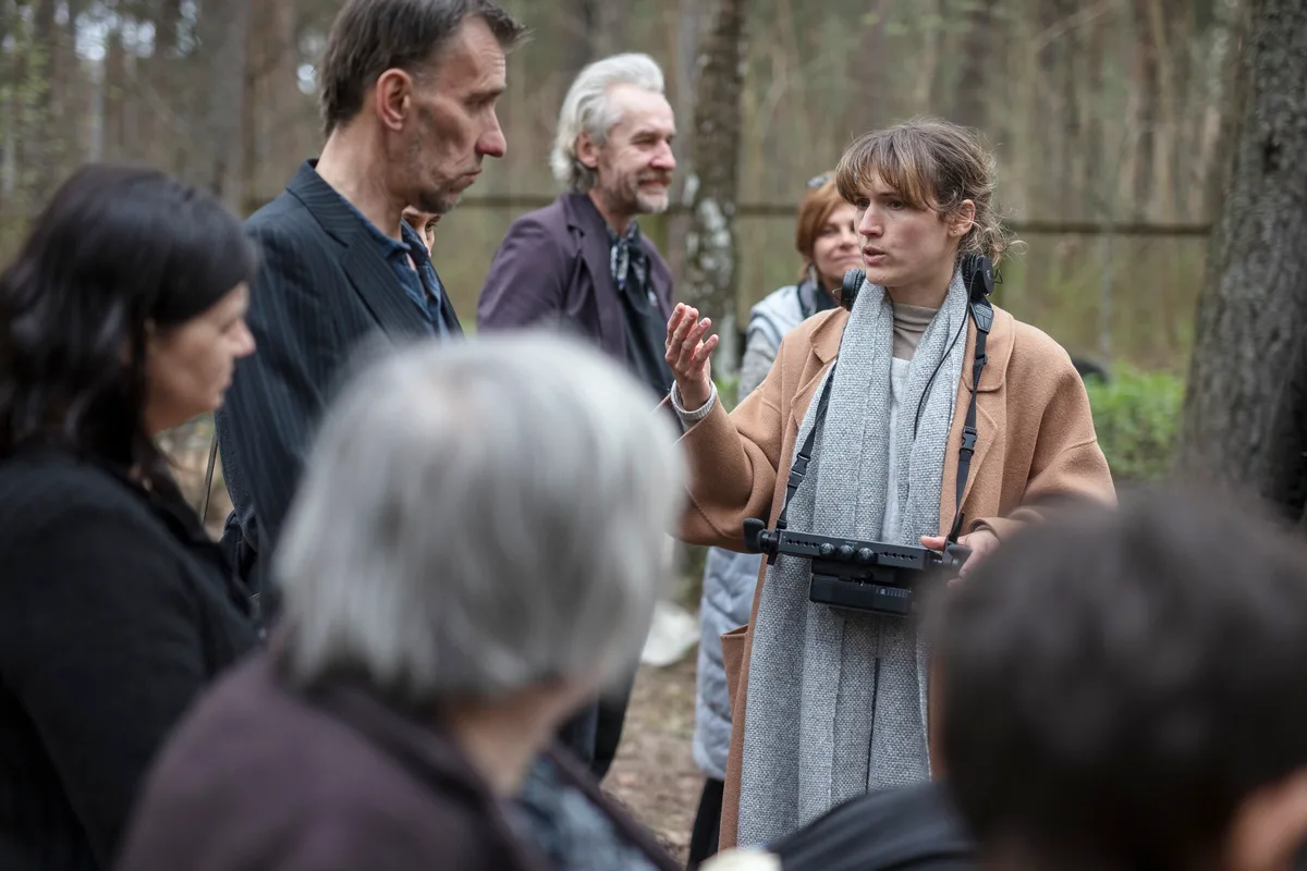 Dinnikova spricht am Set mit mehreren Personen.